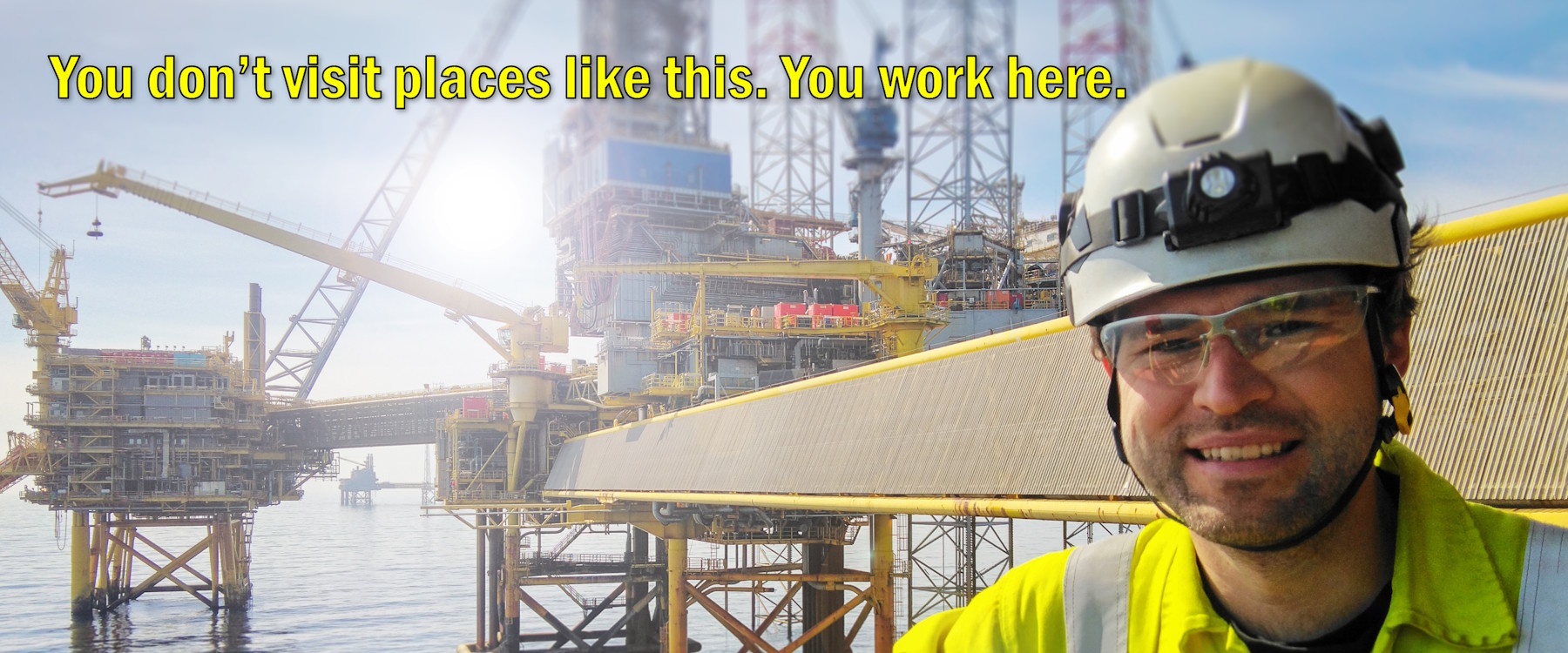 Offshore rigger working on a crane deck platform during active operations